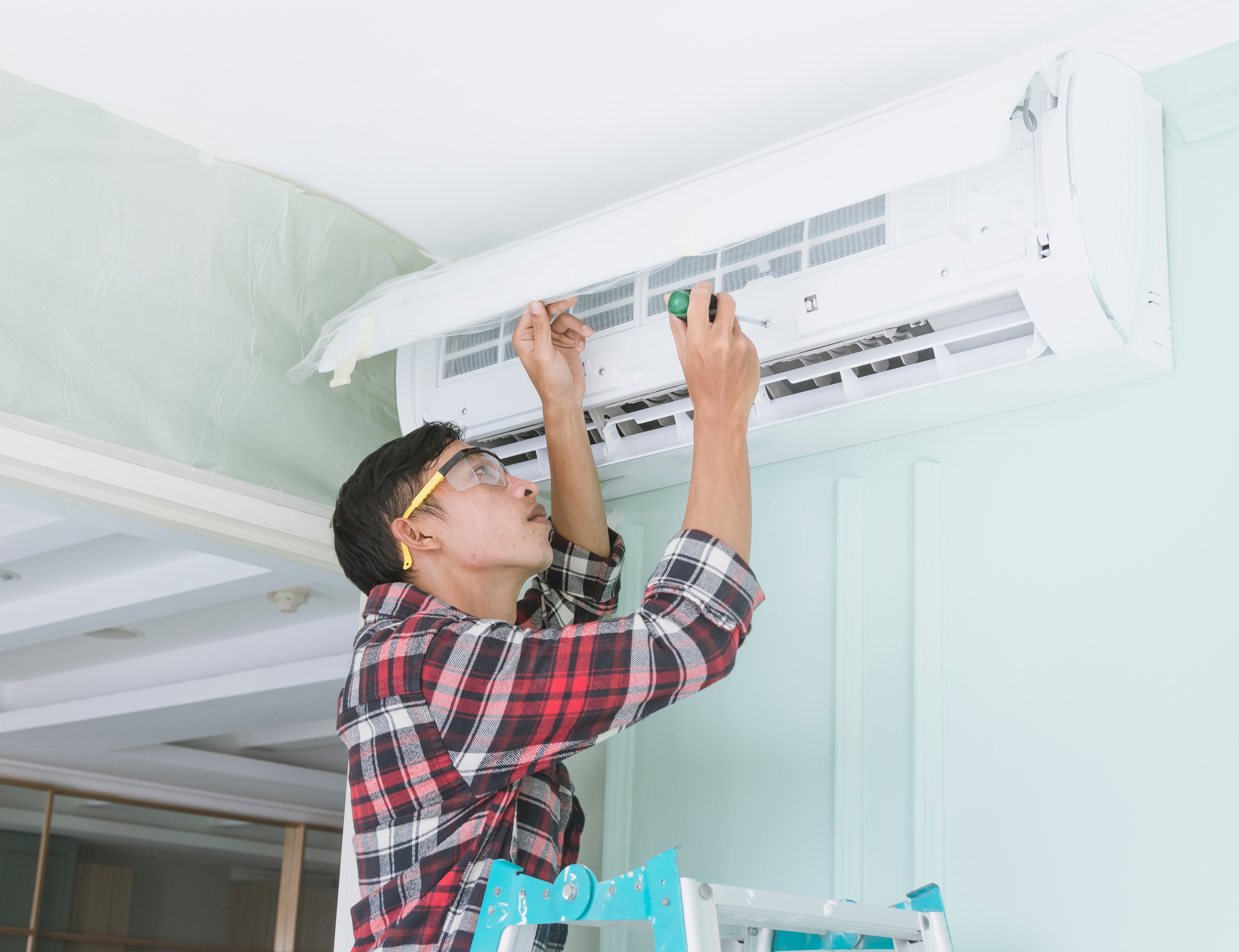 Repairman Inspecting an Air Conditioning Unit